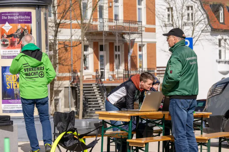The road safety association coding bikes at a table on the square